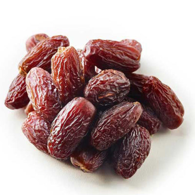 A heap of Medjool dates against a white background.