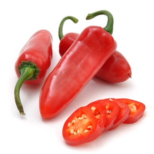 Three Red Jalapenos and some sliced Jalapeno on a white background 